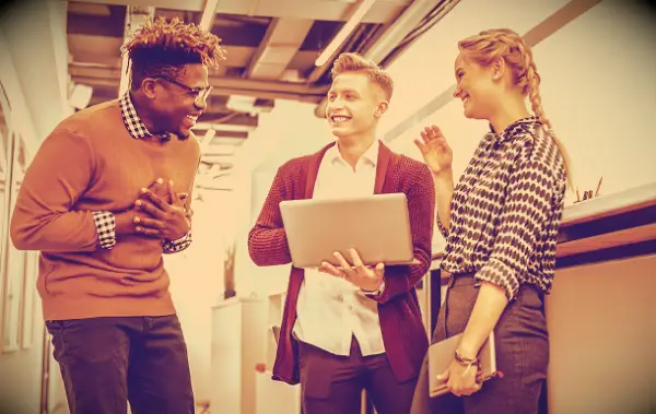 Coworkers in an office laughing about something.