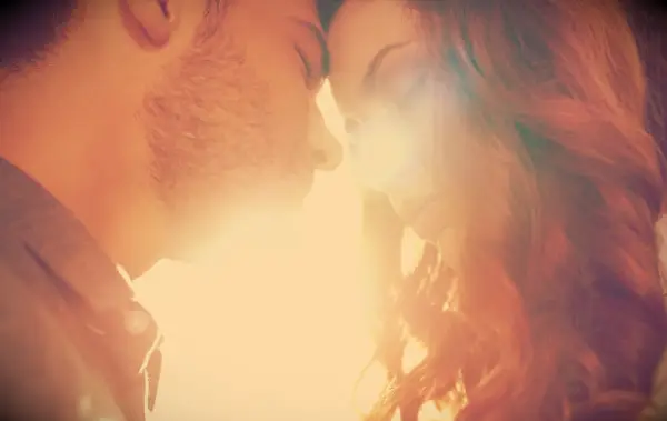 A close up of a couple close to each other, forehead to forehead.