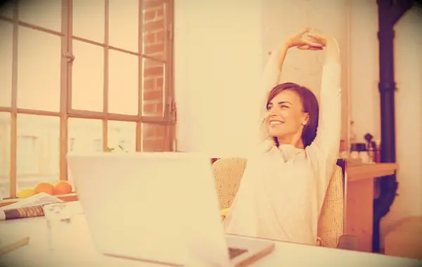 Woman smiling and relaxing while sitting in her office.