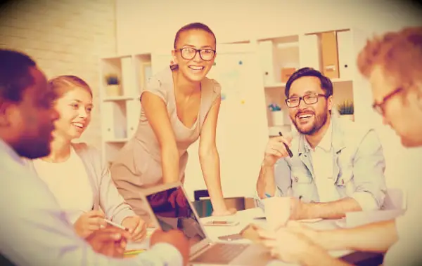 A meeting in the office with people having a good time.