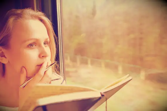 A woman thinking about something while riding the train.