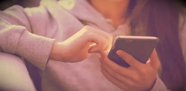 Woman using her phone at night.