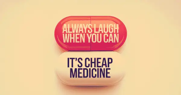 Two medical pills that say that laughter is a cheap medicine.