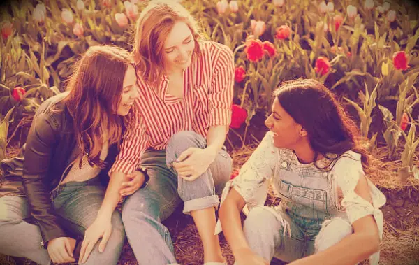 Three women laughing and enjoying their friendship.