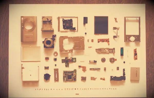 An image of a digital camera taken apart into its individual pieces.